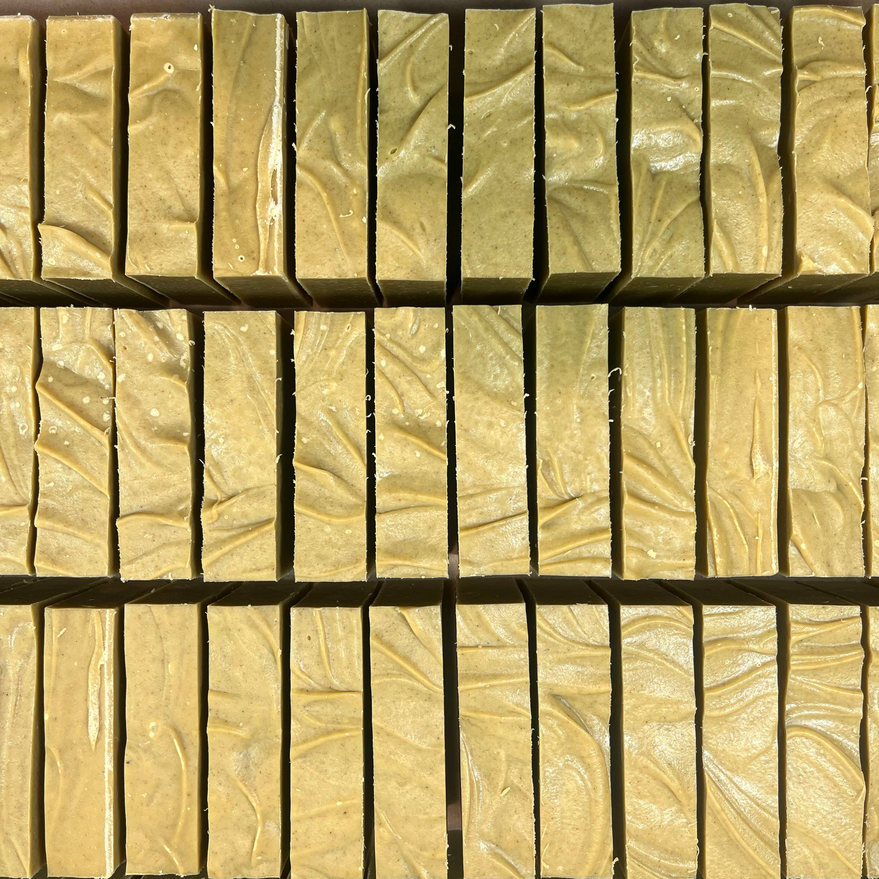 Dandelion bar soap styled with fresh dandelion flowers
