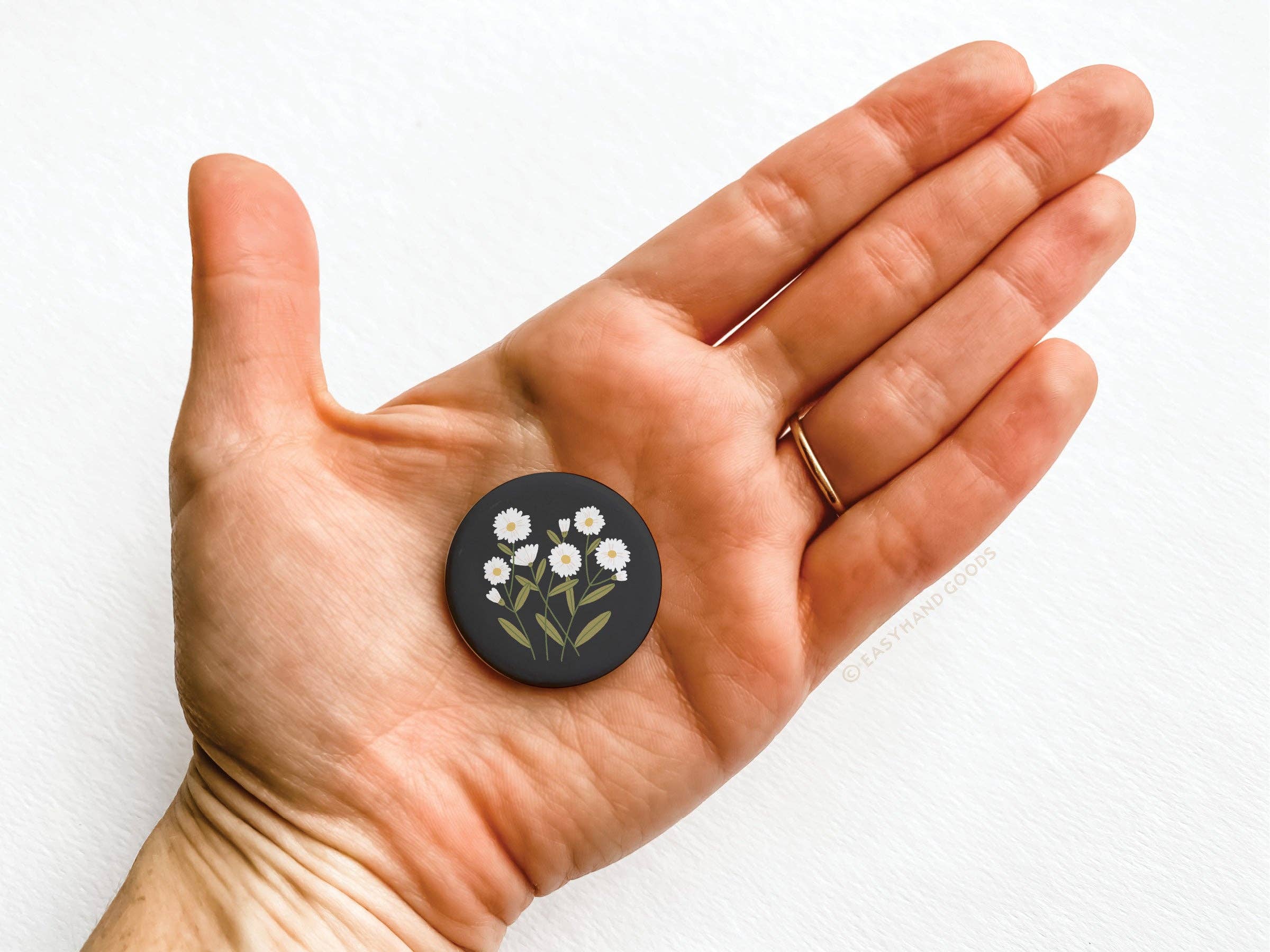 Daisies button pinback shown at angle