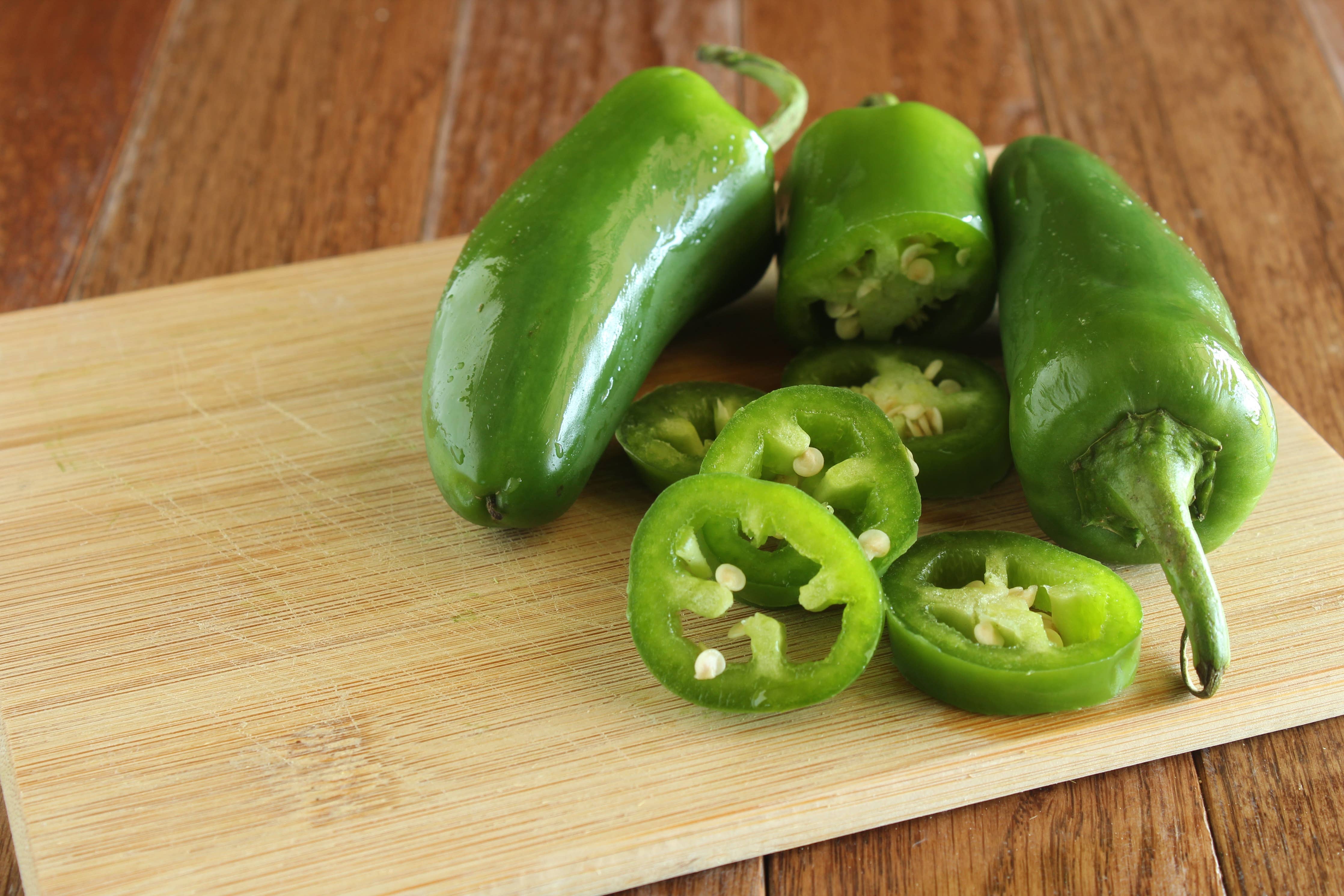 Fresh jalapeño peppers growing on the vine