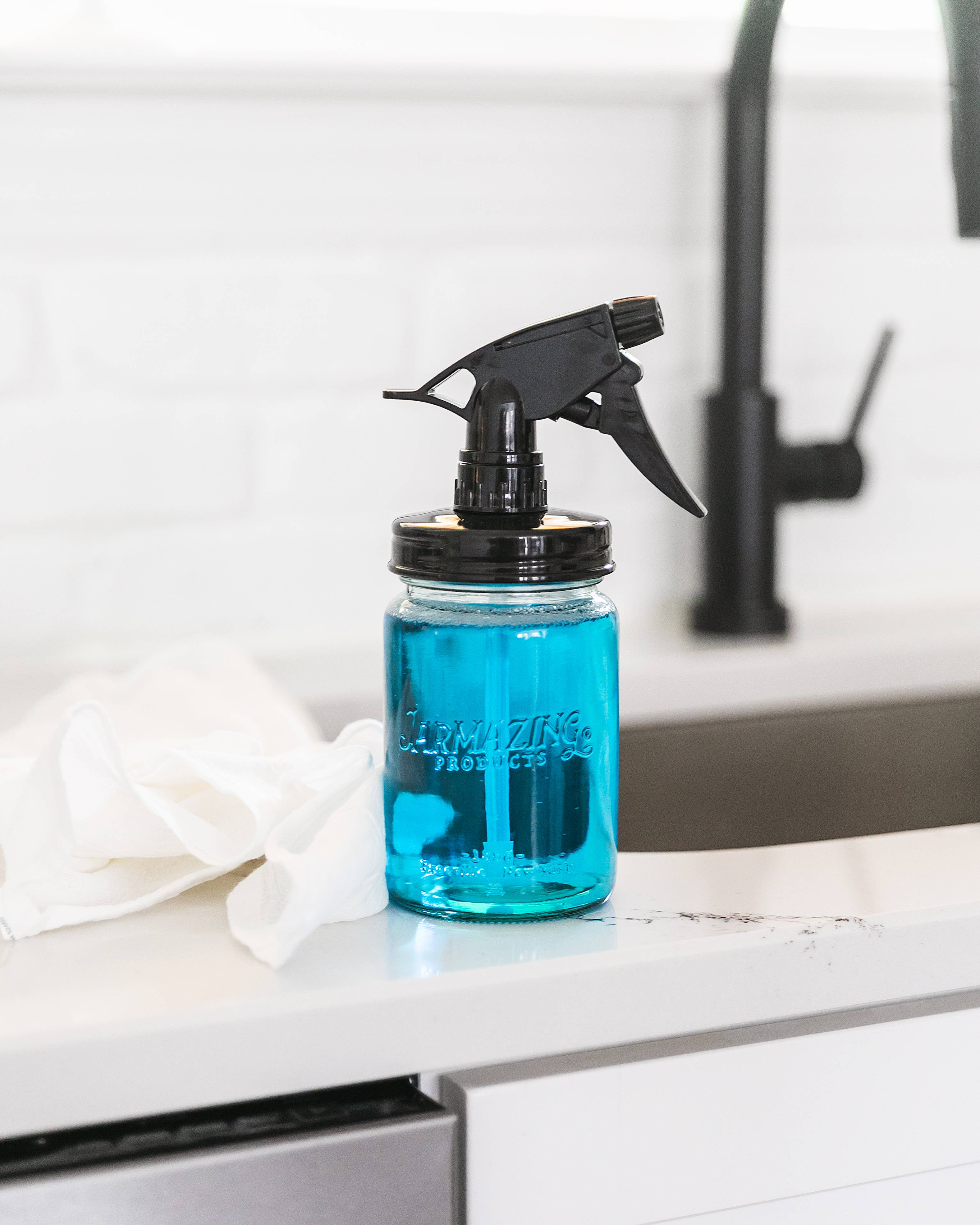 Blue glass mason jar sprayer close-up of spray nozzle