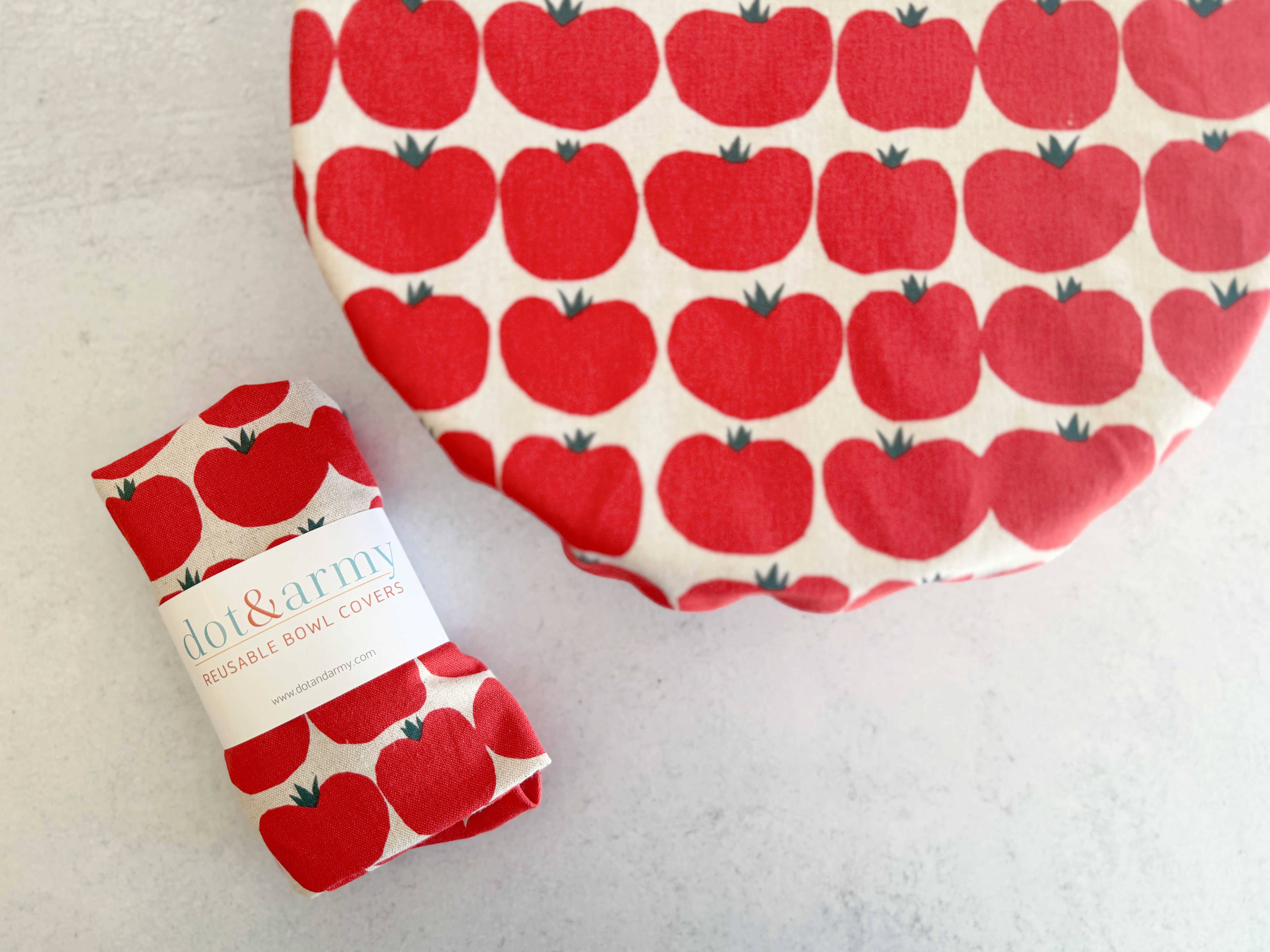 Reusable bowl cover in tomato print stretched over bowl
