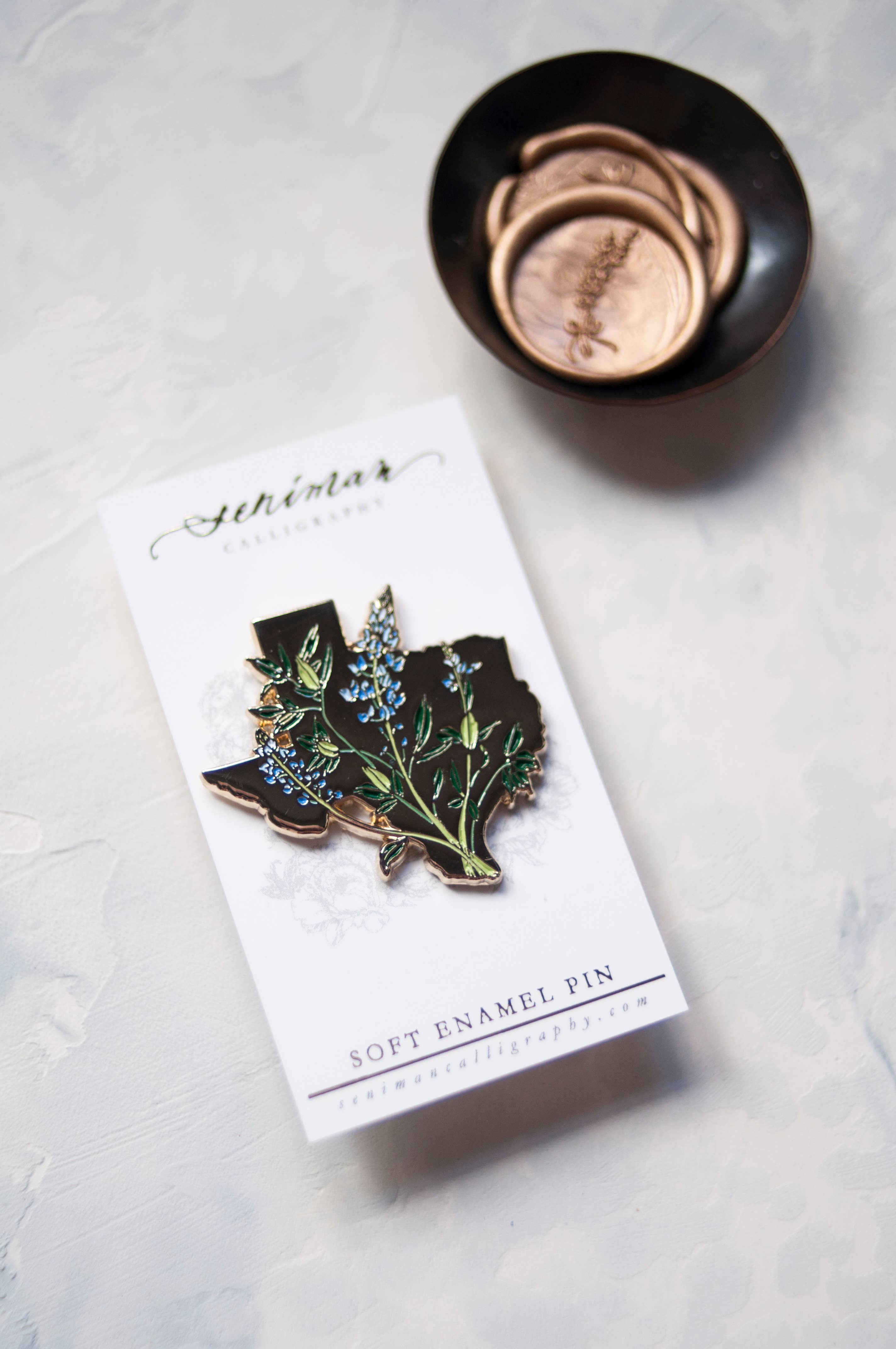 Texas Bluebonnet gold enamel pin on backing card