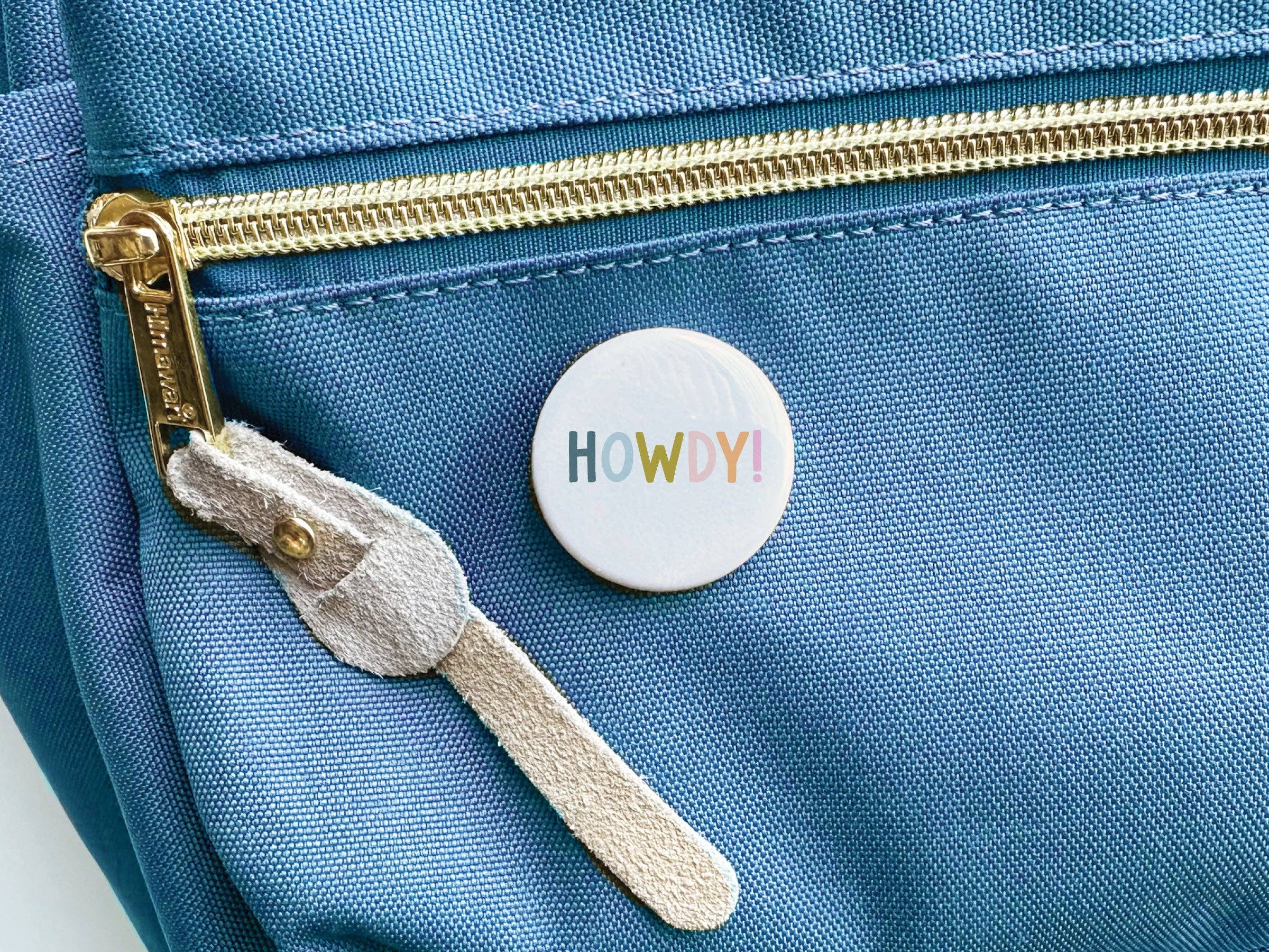Howdy Button displayed with packaging