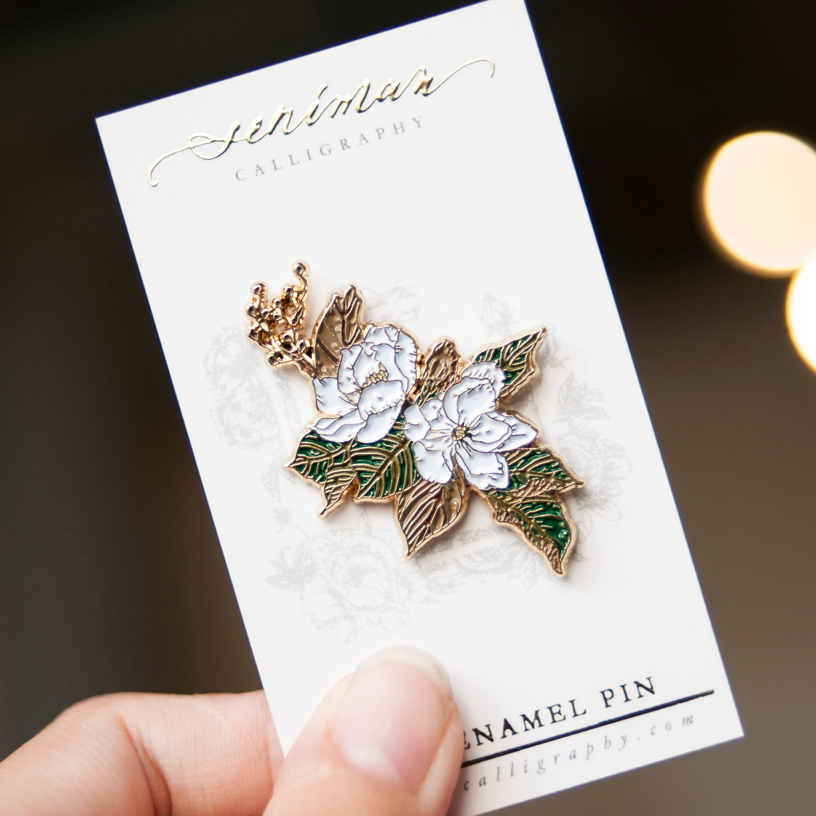 Southern Magnolia gold soft enamel pin on display