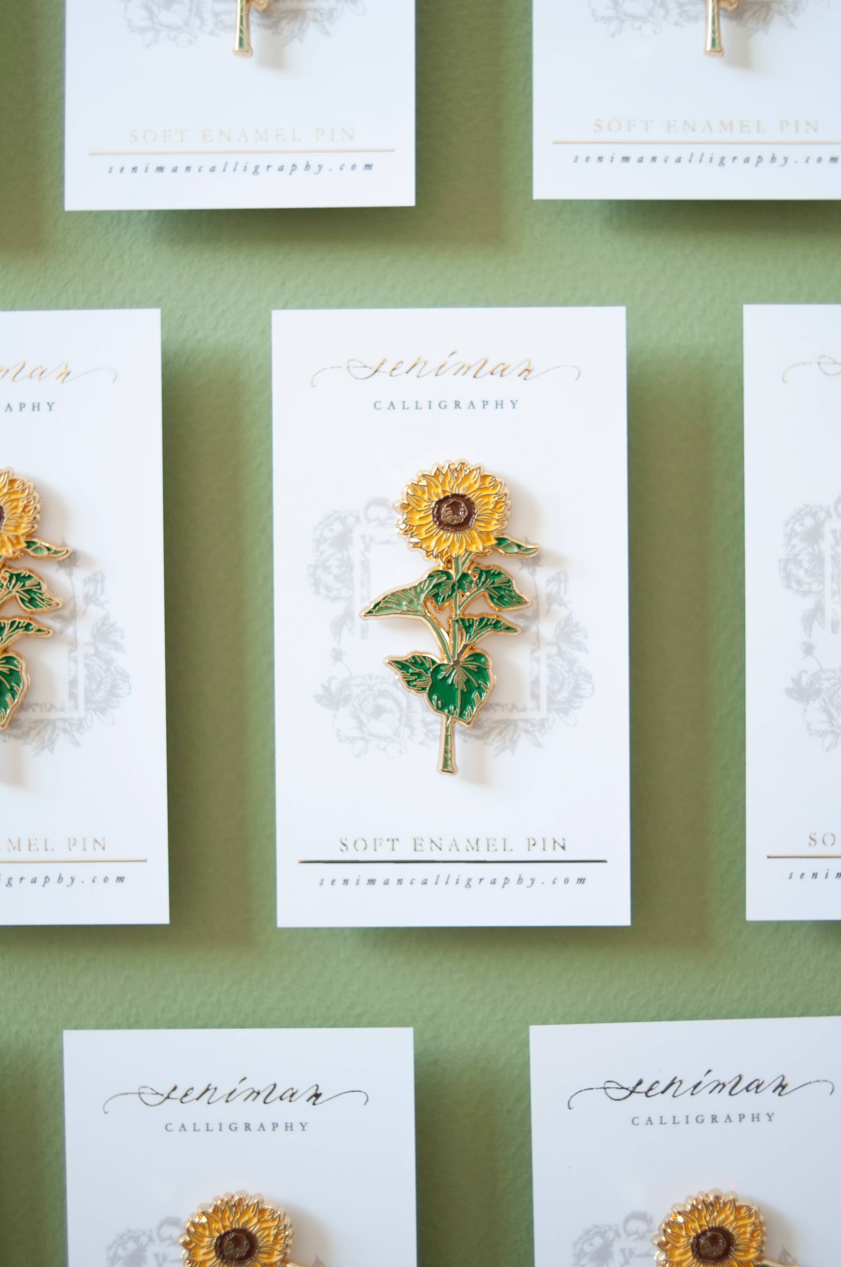 Sunflower enamel pin on backing card