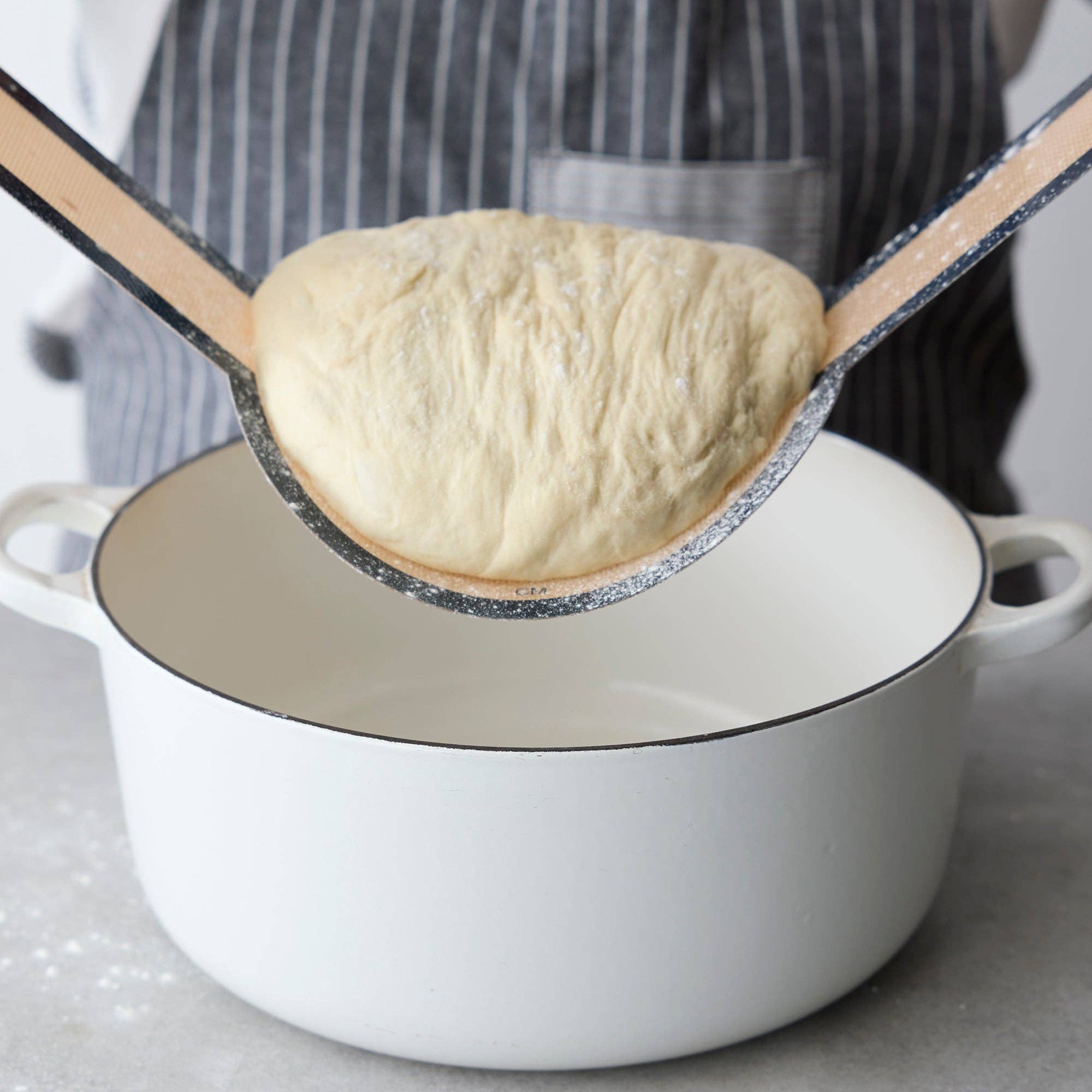 Silicone bread sling in use with Dutch oven