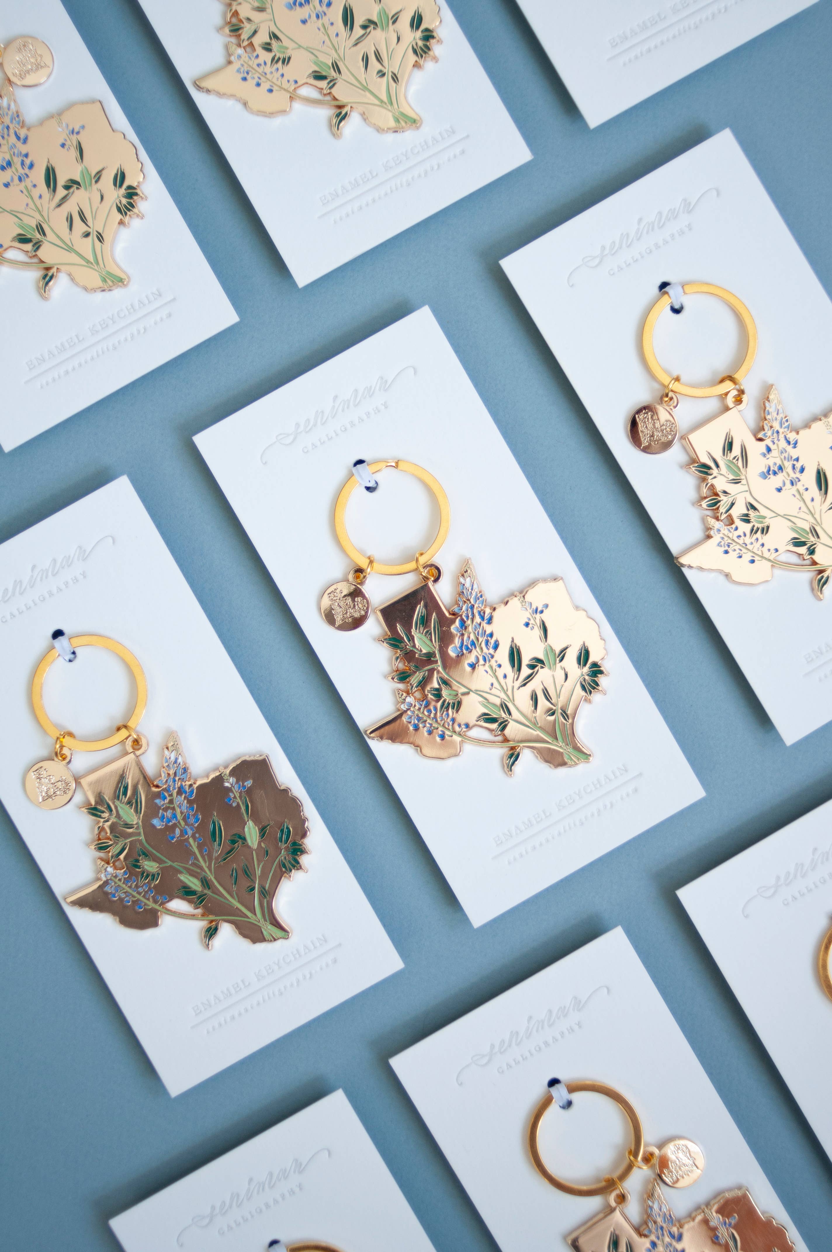 Gold Texas Bluebonnet soft enamel keychain on packaging
