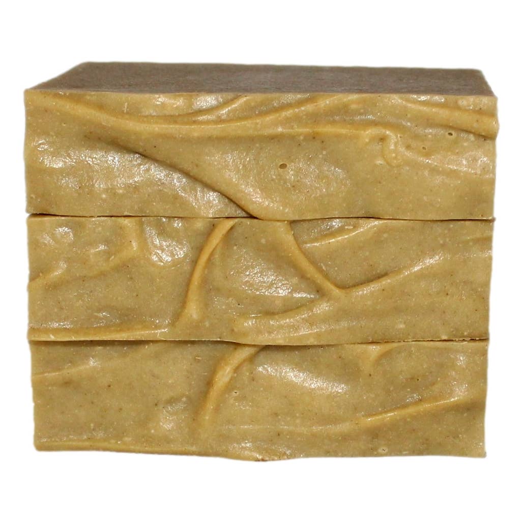 Dandelion bar soap unwrapped showing creamy texture