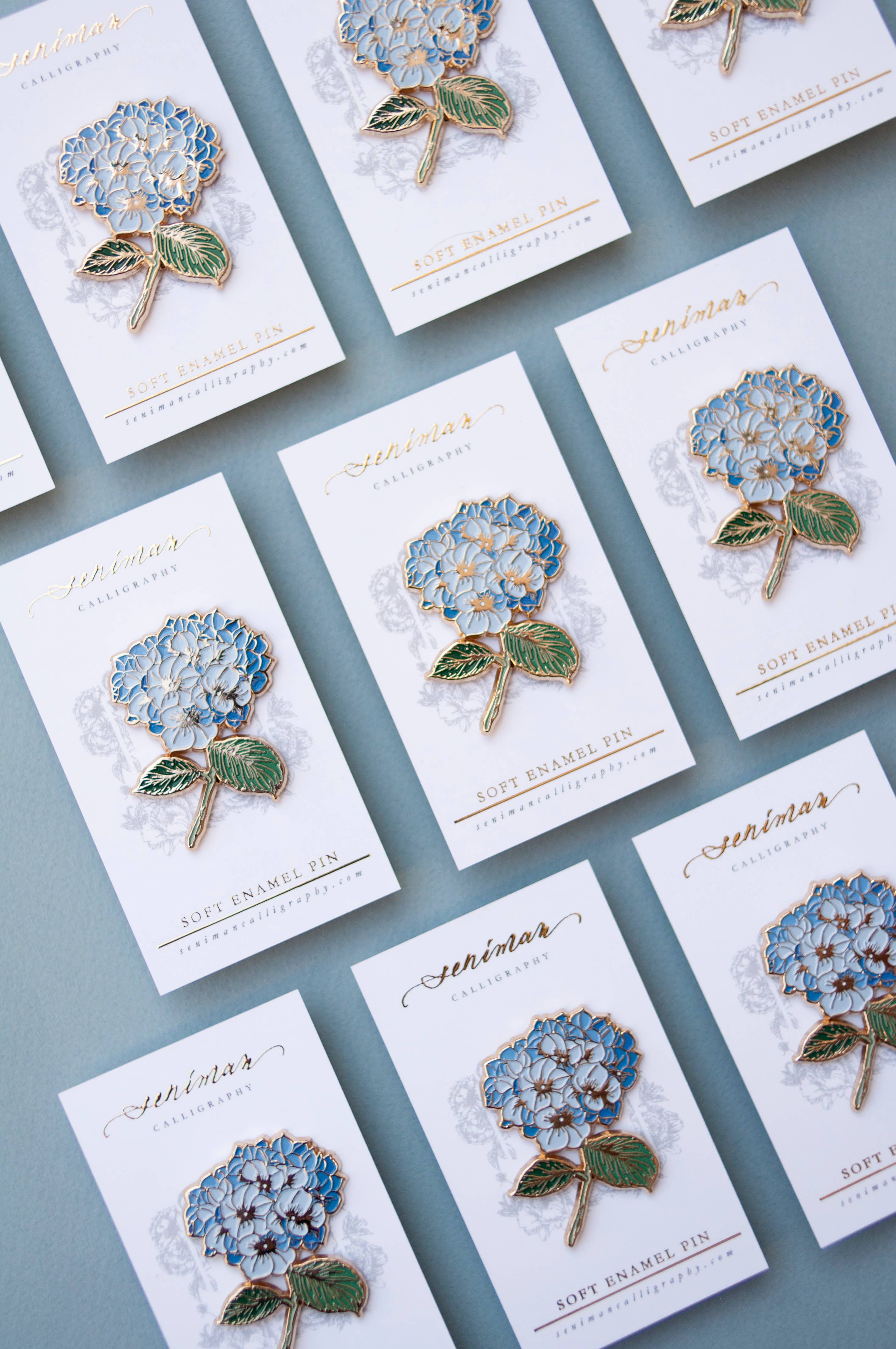 Hydrangea gold soft enamel pin on display