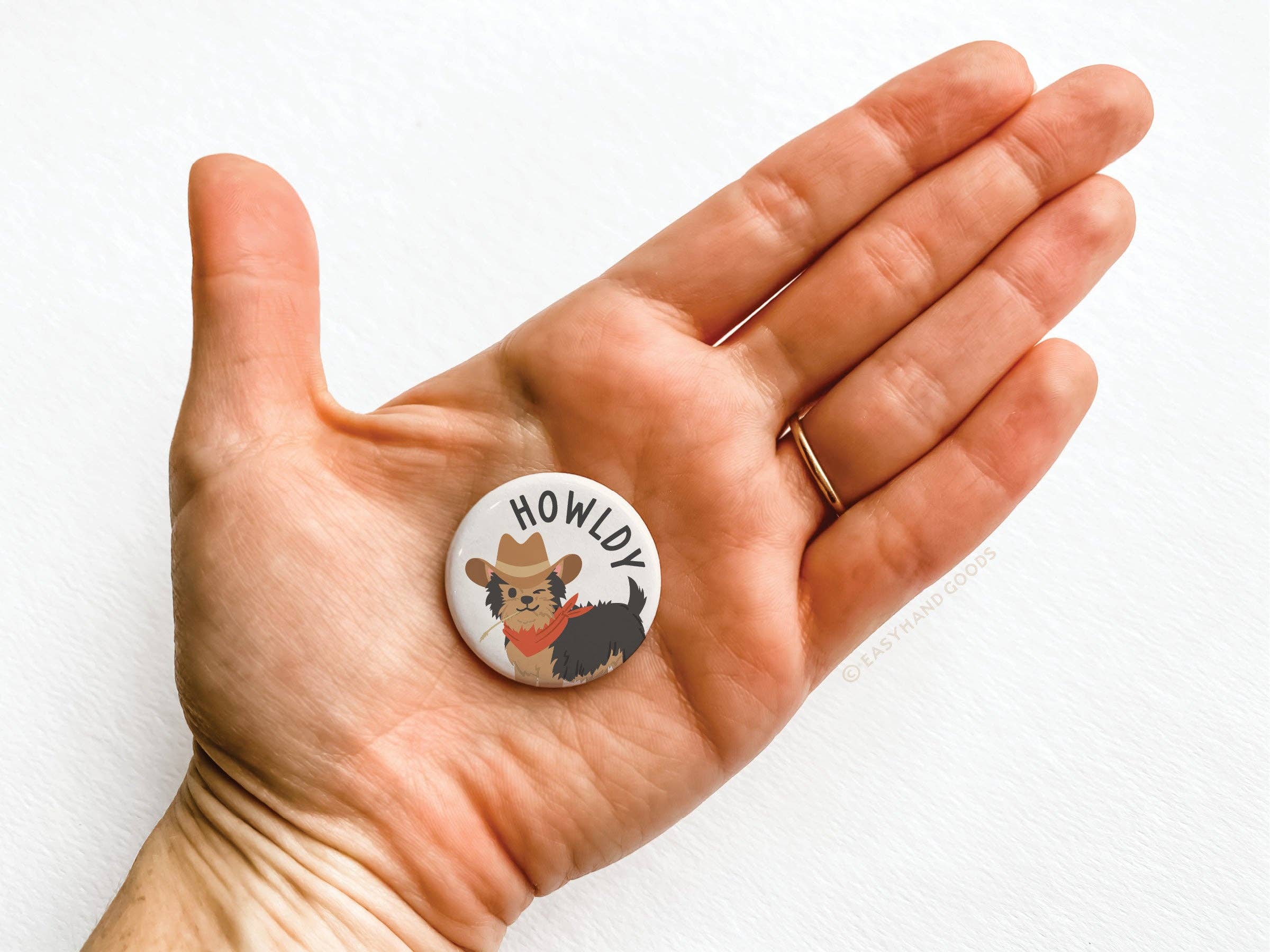 Howldy pin button with playful dog illustration