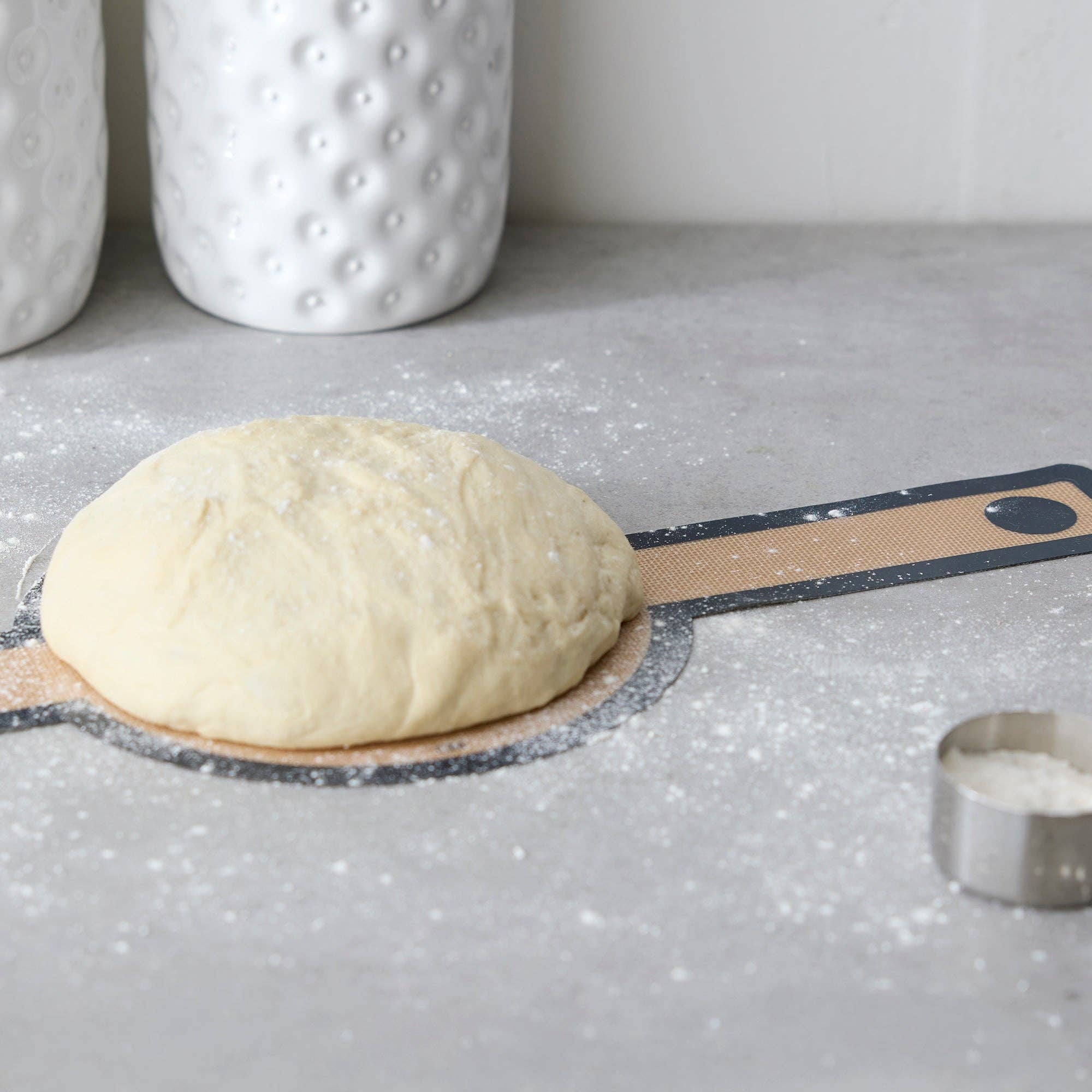 Silicone bread sling holding a loaf of bread