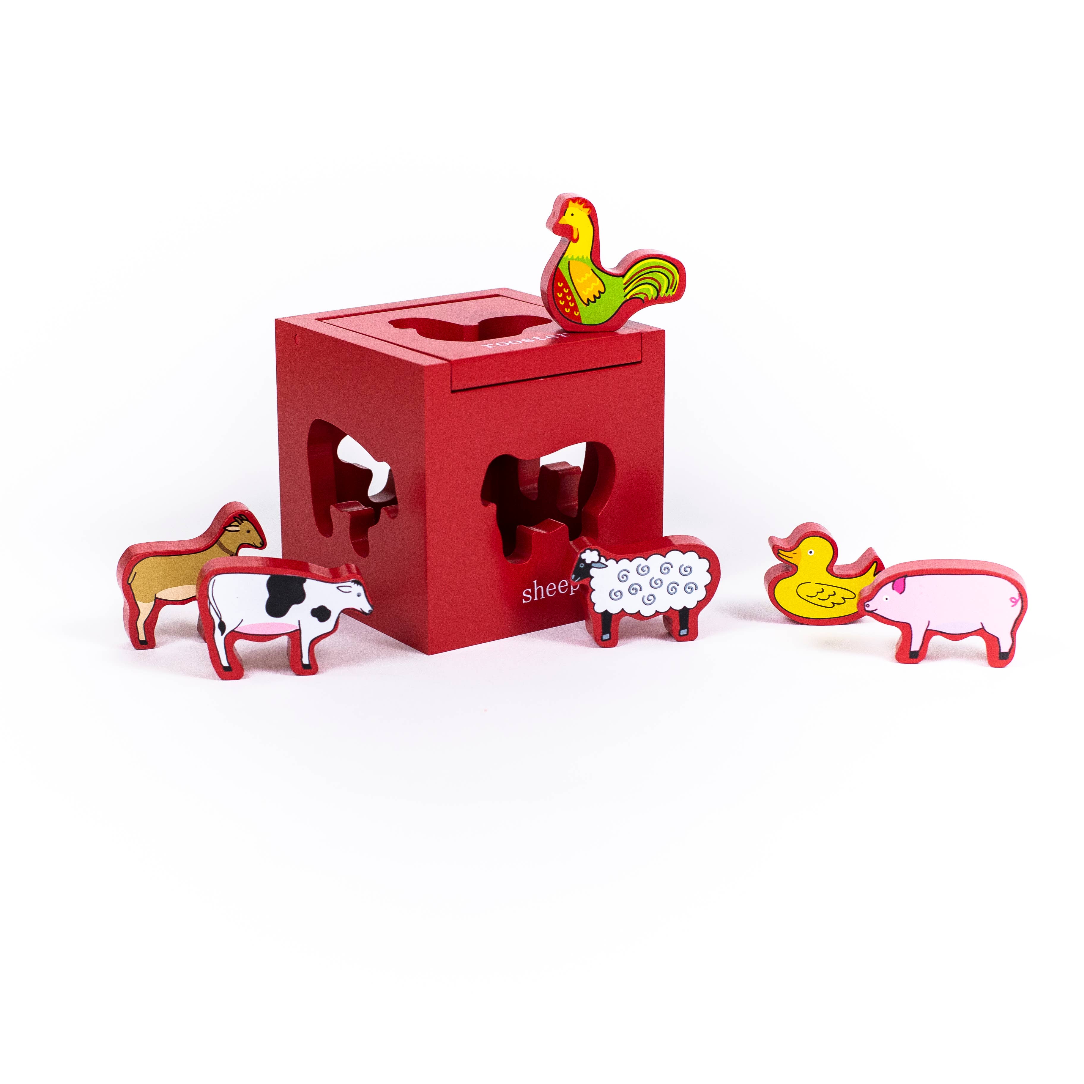 Barnyard Sort and Play toy pieces displayed outside barn