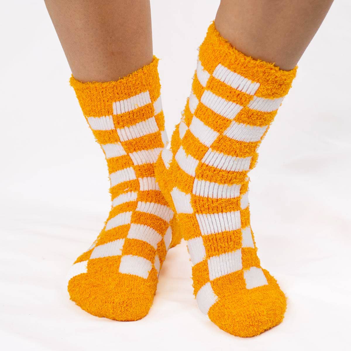 Women's orange and white checkerboard snuggle socks close-up